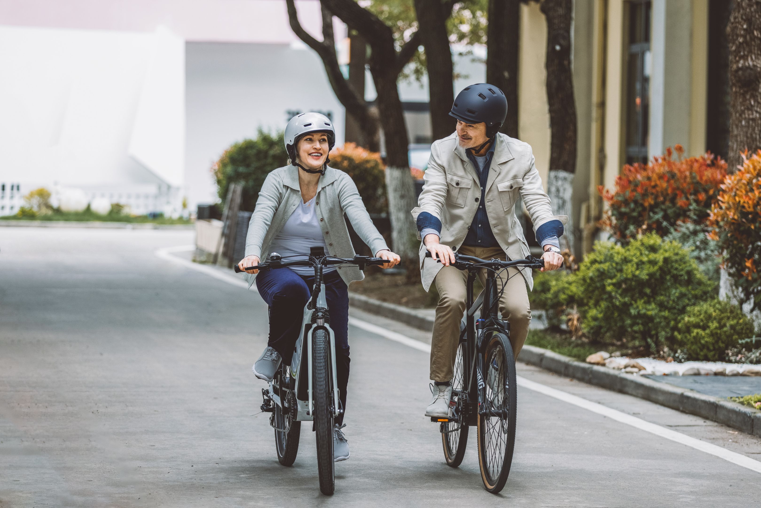A couple cycling together on a city street