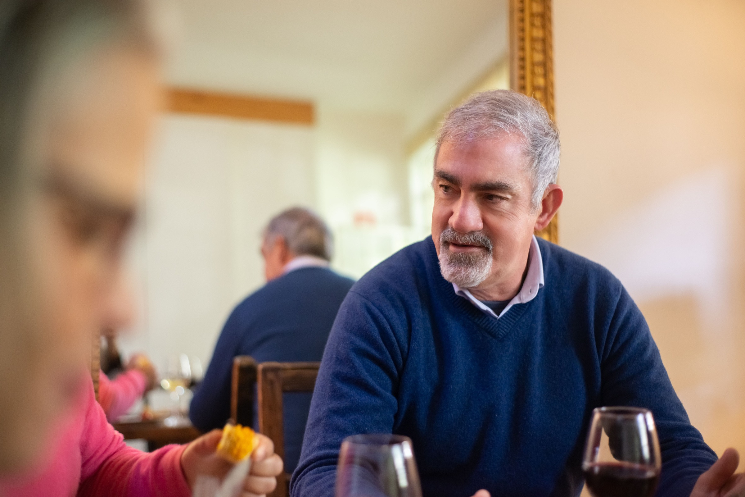 Adults sharing a meal and a conversation at a table